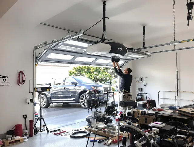 Plantation Garage Door Repair specialist installing smart garage door opener system in Plantation home